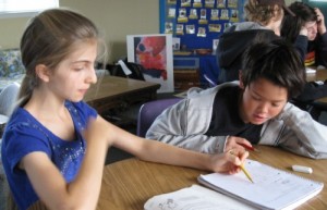 Mariah helps a fellow middle-school student understand a lesson at Living Wisdom School in Palo Alto, CA