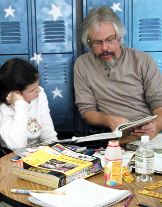 Gary McSweeney helps a middle school student with math at Living Wisdom School in Palo Alto, California.