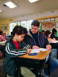 Teacher Eric helps Luke understand a math concept at Living Wisdom School in Palo Alto, California.
