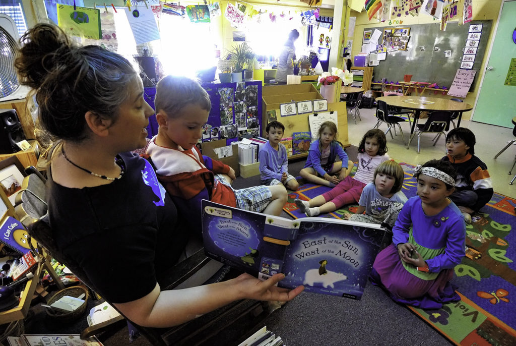 Teacher Mahita Matulich reads to the kindergarten children at Living Wisdom School in Palo Alto